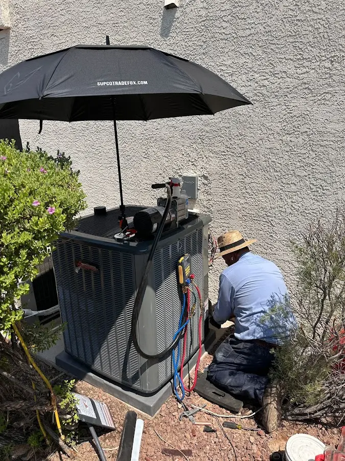 HVAC technician performing outdoor AC maintenance in Springdale